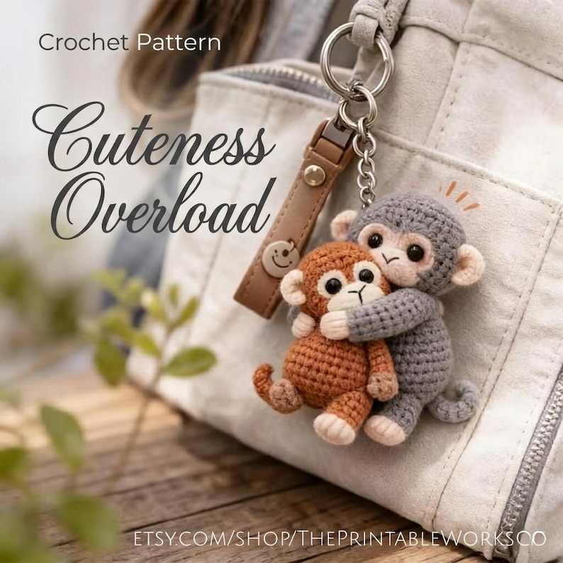 May include: A crocheted keychain featuring two hugging monkeys, one brown and one gray. The keychain is attached to a leather strap with a smiley face charm. Text on the image reads "Cuteness Overload" and "Crochet Pattern".