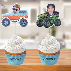 May include: Two cupcakes with white frosting and blue sprinkles. Each cupcake has a topper with a child's face in a monster truck. One truck is blue and orange, the other is green and black. The cupcake liners are blue, and the text "OPTION 1" and "OPTION 2" are visible.