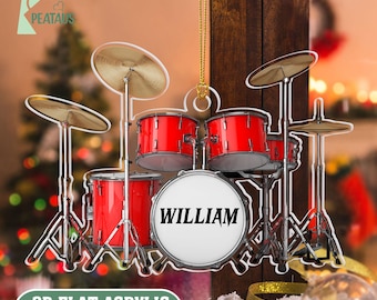 May include: A red and silver drum set ornament with the name "WILLIAM" on the bass drum. The ornament is made of acrylic and includes cymbals and drum stands. The text "2D FLAT ACRYLIC NOT 3D" is at the bottom.
