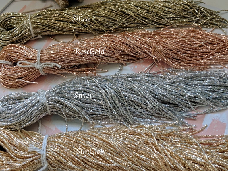 May include: Four spools of metallic thread in different colors: Silica, Rose Gold, Silver, and SunGlow.
