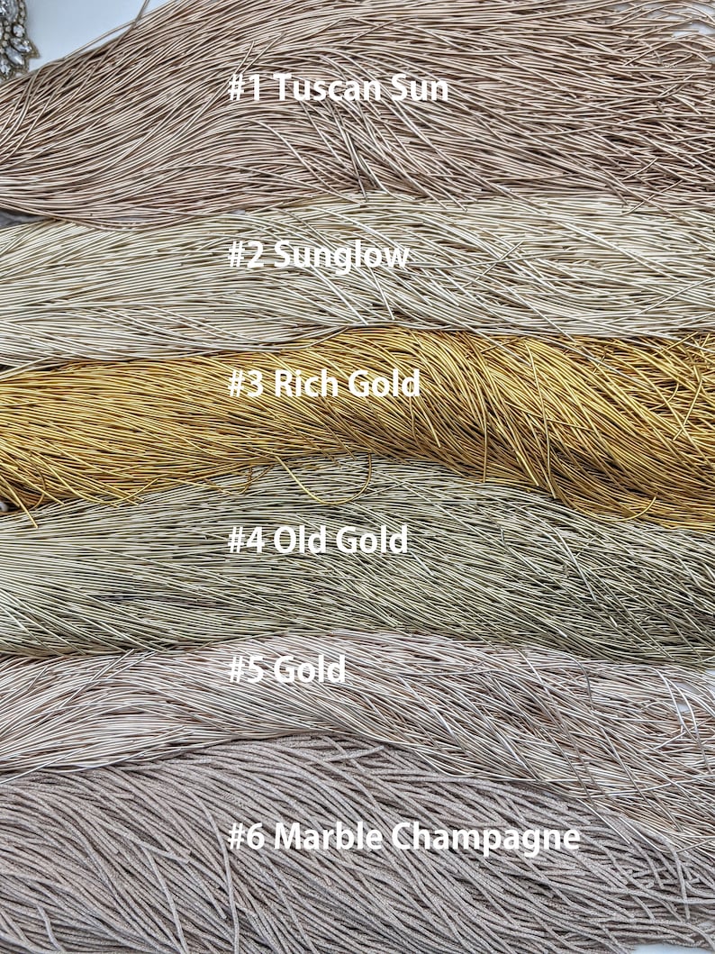 May include: Six different colors of metallic wire, labeled #1 Tuscan Sun, #2 Sunglow, #3 Rich Gold, #4 Old Gold, #5 Gold, and #6 Marble Champagne.