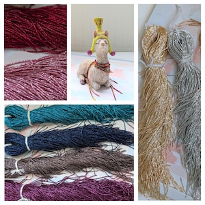 May include: Assortment of metallic seed beads in various colors, including teal, navy, brown, burgundy, gold, and silver. The beads are arranged in bundles and are ready for crafting projects.