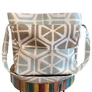 Large zippered and self standing knitting project bag with deep pockets.  It is made using a heavy decorator's fabric which is water and stain resistant.  It has a modern geometric pattern   We used the same pattern in two colors.