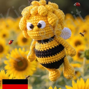 May include: A crocheted bee doll with yellow and black stripes, white wings, and large eyes, set against a backdrop of sunflowers. The doll is surrounded by real bees and ladybirds. The German flag is in the lower left corner.