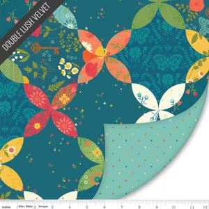 May include: A teal fabric featuring a repeating pattern of colorful floral and butterfly motifs in orange, yellow, red, and white, with a corner folded back to reveal a light blue underside with small pink and green polka dots and a 12-inch ruler.