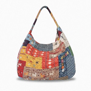 May include: A patchwork shoulder bag with a single strap. The bag features a variety of colorful fabric squares in shades of red, yellow, blue, and brown. The design includes geometric and animal patterns.