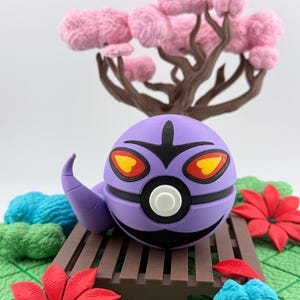 May include: A purple, spherical character with black accents, yellow and red eyes, and a curved antenna, resting on a brown wooden bridge. The scene includes red flowers, blue and green textured elements, and a pink-flowered tree.