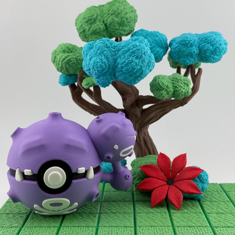 May include: A purple and white cartoon character with a round body and a smaller attached character. A brown tree with green and blue textured foliage is in the background. A red flower and green textured base complete the scene.