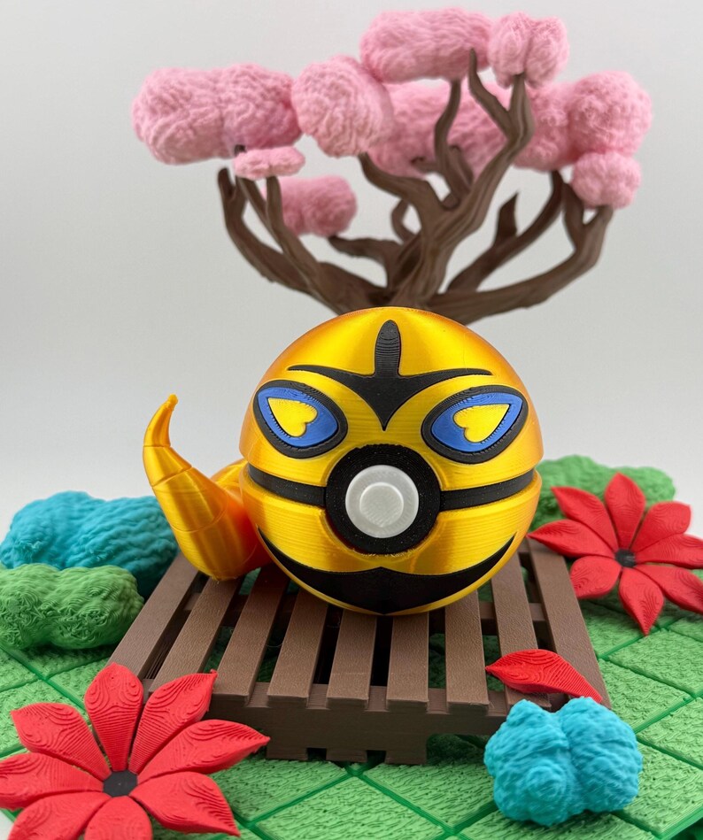 May include: A golden, spherical decorative object with black and blue accents, resembling a stylized insect. It rests on a brown wooden platform, surrounded by red flowers, blue and green textured shapes, and a pink tree.