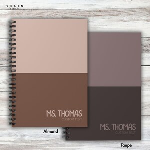 May include: Two spiral-bound notebooks, one almond and one taupe, each split horizontally into two color blocks. The top half is a lighter shade, and the bottom half is a darker shade. The text "MS. THOMAS CUSTOM TEXT" is printed on the bottom half of each notebook.