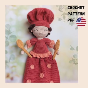 May include: A handmade crochet doll dressed as a chef, wearing a red chef's hat and dress, holding two wooden spoons. The doll has brown curly hair and closed eyes. The text "CROCHET PATTERN PDF" is displayed with the American flag.