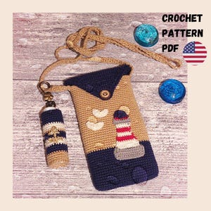 May include: A crochet pattern PDF for a tan and navy blue phone pouch featuring a lighthouse motif, a matching lip balm holder with an anchor charm, and a long strap. The text CROCHET PATTERN PDF is visible alongside a small United States flag icon.
