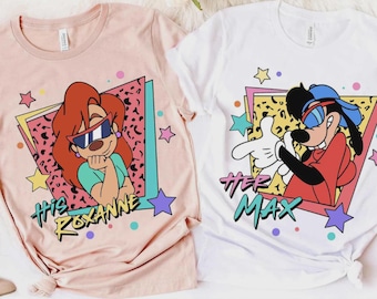 May include: Two t-shirts, one pink and one white, featuring cartoon characters. The pink shirt has Roxanne with the text "HIS ROXANNE". The white shirt has Max with the text "HER MAX". Both shirts have a retro 90s design with stars and geometric shapes.