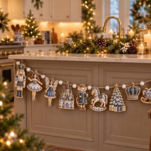 May include: A decorative garland featuring a series of hanging ornaments in blue and white patterns, including a nutcracker, ballerina, fairy, castle, mouse, rocking horse, Christmas tree, crown, sleigh, and clock, strung on a white pom-pom rope.