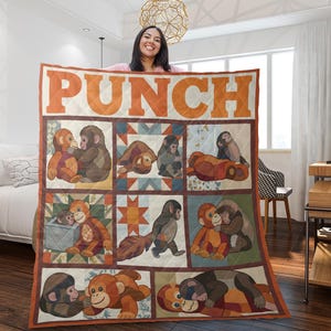 May include: A quilted blanket featuring a repeating pattern of cartoon monkeys in various poses. The word "PUNCH" is displayed in large orange letters at the top. The blanket has a cream background with orange and brown accents.