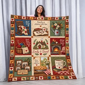 May include: A quilted throw blanket featuring a grid of nine illustrations including a rocking chair, a book with glasses, a flower-filled watering can, a yarn basket, a house, a fireplace, family photos, a pie, and a mug with the text Emily & David.