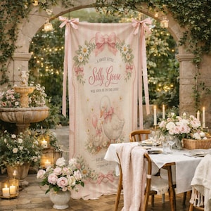 May include: A vertical fabric banner featuring a pink and white striped background with a central illustration of two geese, floral accents, and pink bows. The text reads A sweet little Silly Goose will soon be on the loose! with space for details.