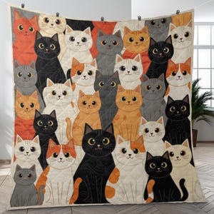 May include: A quilted throw blanket featuring a repeating pattern of cartoon cats in various colors including black, white, orange, and gray. The cats have large eyes and are arranged in a dense grid across the entire surface of the fabric.
