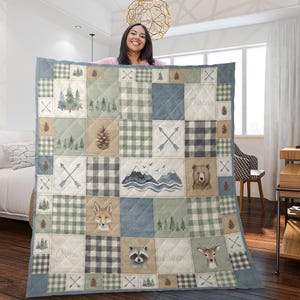 May include: A patchwork quilt with a woodland theme. The quilt features squares with forest scenes, animals, and plaid patterns in shades of green, blue, and tan. The name "Owen" is printed on the quilt.