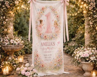 May include: A personalised banner for a first birthday celebration. The banner features a large number one, floral wreath, and two fairy illustrations. The text reads "Amelia's fairy first birthday" with event details. Pink ribbons are attached at the top.