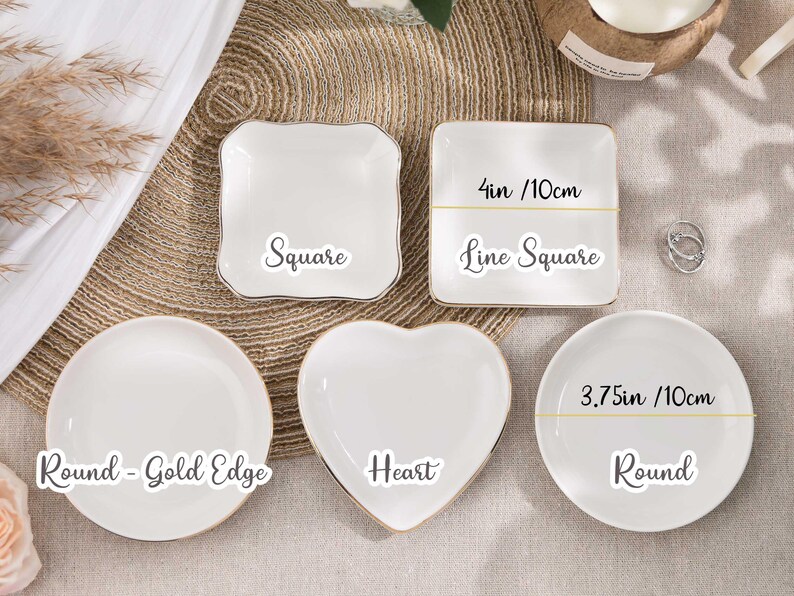 May include: A selection of white ceramic dishes in different shapes: square, heart, and round. The square dish is 10cm wide. The round dish is 10cm wide. Each dish has a gold edge and is labelled with its shape.