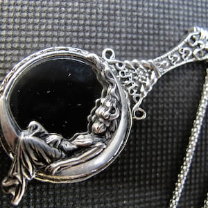 Moon Goddess sitting on a  Looking Glass Necklace  in Antique Silver with a Stainless Steel  24 inch Rolo chain