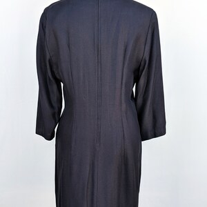May include: A black knee-length dress with a zipper down the back.
