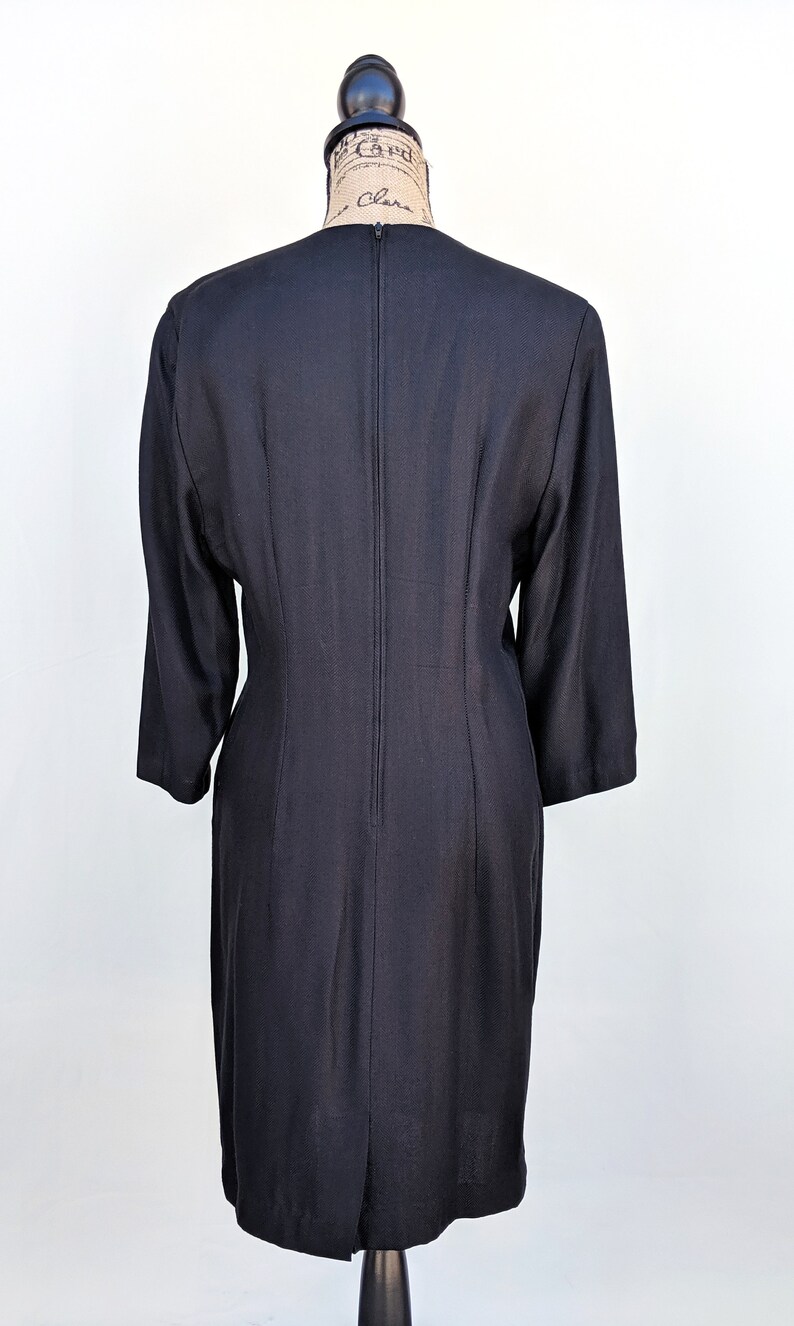 May include: A black knee-length dress with a zipper down the back.
