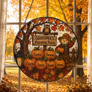 May include: A circular stained glass-style hanging sign featuring an autumn scene with a scarecrow, an owl, and a lantern. The sign displays the text "GRANDMA'S Pumpkin Patch" and includes six pumpkins labeled with the names Sophia, Thomas, Charlie, David, Amelia, and Emma.