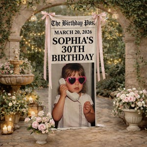 May include: A vertical fabric banner featuring the text The Birthday Post, MARCH 20, 2026, SOPHIA'S 30TH BIRTHDAY, and a photograph of a child wearing pink heart-shaped sunglasses while holding a telephone receiver to their ear.