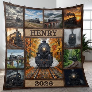 May include: A quilted blanket featuring multiple images of steam trains in various settings. The central panel displays a black train on tracks amidst autumn foliage, with the name "HENRY" above and "2026" below. The blanket has a brown border.