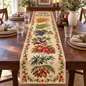 May include: A quilted table runner featuring the Seven Species with botanical illustrations of wheat, barley, grapes, figs, pomegranates, olives, and dates. The design includes the text "The Seven Species" and Hebrew labels, framed by a floral vine border.