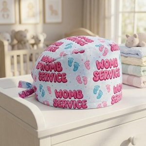 May include: A light blue surgical scrub cap with the words "WOMB SERVICE" in pink bubble letters. The cap is patterned with pink and blue baby footprints. A tie is attached to the cap.