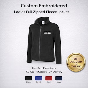 May include: Black full-zip fleece jacket with a stand-up collar. The jacket has long sleeves and a zipper closure. The text "YOUR TEXT/ LOGO HERE" is displayed on the chest. The image also shows color options: black, royal blue, red, and navy.
