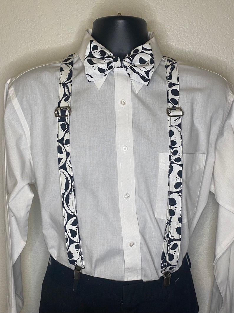 May include: Black and white bow tie and suspenders with a pattern of Jack Skellington's face from the Nightmare Before Christmas.