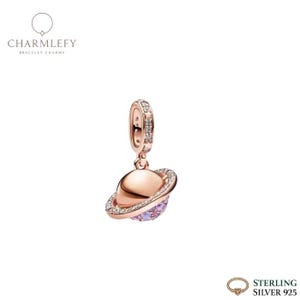 May include: A rose gold-colored charm with a planet design. The charm features a planet with a ring of clear crystals and a purple and pink center. The top of the charm has a loop with clear crystals. The brand name "CHARMLEFY" is at the top.