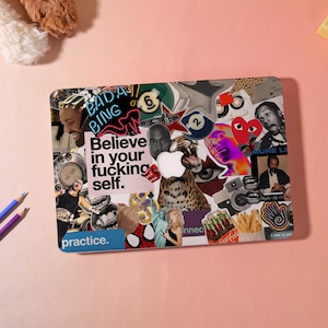 May include: A laptop lid covered in a dense collage of stickers featuring diverse imagery, including a leopard, a human eye, a red heart, a hand gesture, french fries, and text that reads BADA BING and Believe in your fucking self.