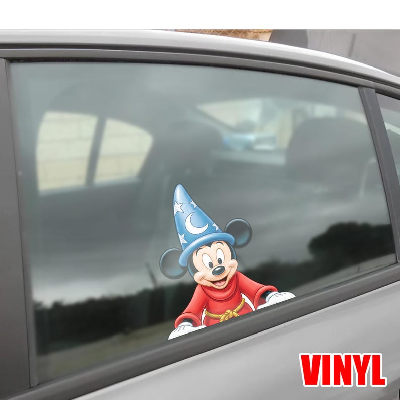 May include: A vinyl decal of Mickey Mouse in a sorcerer's outfit, with a blue hat adorned with stars and a crescent moon. The character is wearing a red robe with a gold rope belt. The word "VINYL" is printed in red.