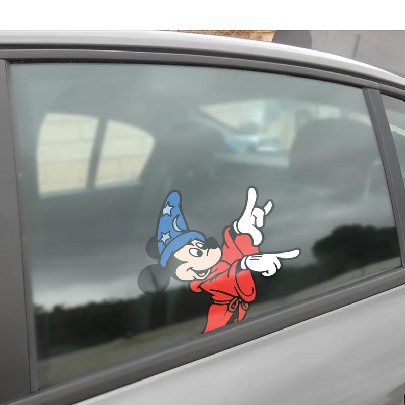 May include: A colorful car decal featuring Mickey Mouse dressed as a wizard. Mickey is wearing a blue wizard hat with stars and a red robe. He is making a hand gesture with his fingers and pointing.