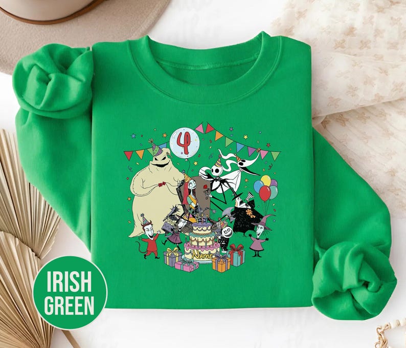 May include: Irish green sweatshirt featuring a colorful graphic of characters from a popular animated movie celebrating a birthday. The design includes a cake, presents, balloons, and the number 4.