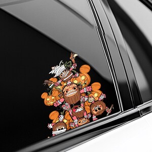 May include: A colorful Halloween-themed sticker featuring a cluster of cartoonish characters with pumpkin heads and wrapped in bandages. The characters are in shades of orange, brown, pink, and white, with some holding small weapons.