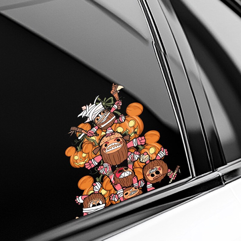 May include: A colorful Halloween-themed sticker featuring a cluster of cartoonish characters with pumpkin heads and wrapped in bandages. The characters are in shades of orange, brown, pink, and white, with some holding small weapons.