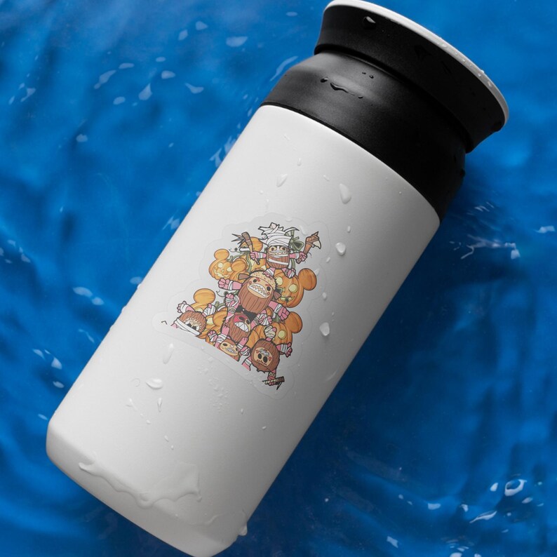 May include: White insulated travel mug with a black lid. The mug features a colorful sticker with cartoon characters in shades of brown, orange, and pink. The background is a vibrant blue.