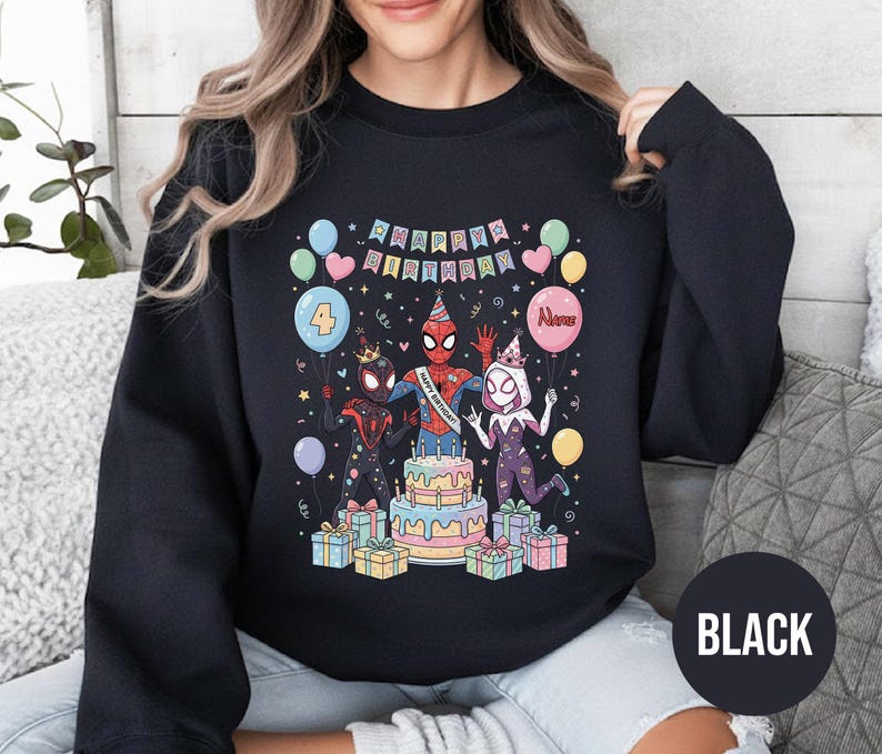 May include: Black sweatshirt featuring a colorful birthday graphic with Spider-Man characters, a cake, balloons, and the text "Happy Birthday." The number "4" is on a balloon. The word "Name" is on a balloon. The word "BLACK" is on a black circle.