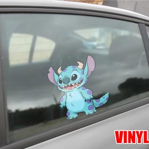 May include: A blue and purple vinyl decal of the character Stitch from Lilo & Stitch, applied to a car window. The decal features Stitch's large ears, horns, and a wide grin. The word "VINYL" is printed in red.
