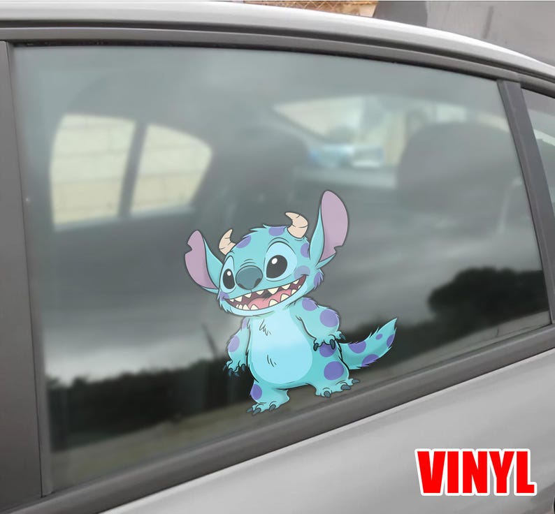 May include: A blue and purple vinyl decal of the character Stitch from Lilo & Stitch, applied to a car window. The decal features Stitch's large ears, horns, and a wide grin. The word "VINYL" is printed in red.