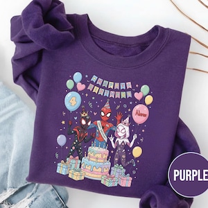 May include: Purple sweatshirt featuring a colorful graphic of Spider-Man characters celebrating a birthday. The design includes a cake, balloons, and the text "Happy Birthday". The number "4" is also displayed.