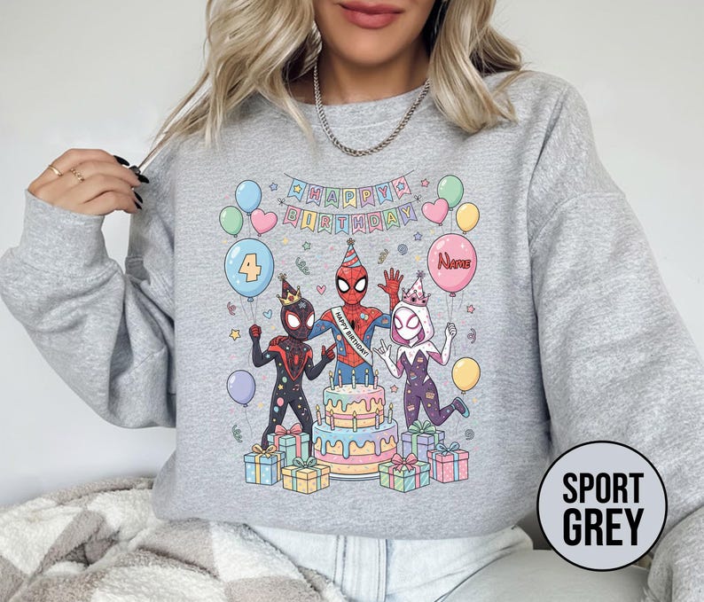 May include: Sport grey sweatshirt featuring a colorful birthday design with Spider-Man characters, balloons, a cake, and the text "Happy Birthday". The number "4" is on a balloon. Presents are at the bottom.