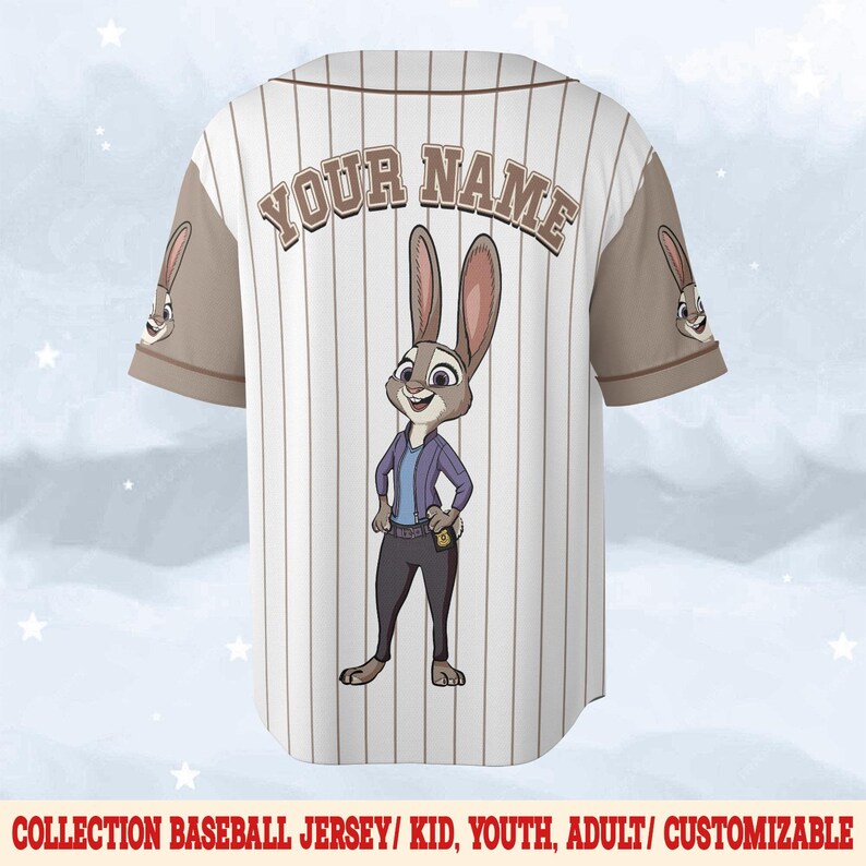 May include: White baseball jersey with brown pinstripes and sleeves. Features a cartoon rabbit character on the back, with the text "YOUR NAME" above. The jersey has a button-up front and a collar. The text "COLLECTION BASEBALL JERSEY/ KID, YOUTH, ADULT/ CUSTOMIZABLE" is at the bottom.