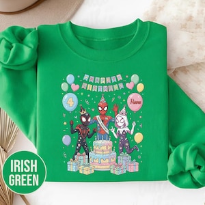 May include: Irish green sweatshirt featuring a colorful graphic of Spider-Man characters celebrating a birthday. The design includes a cake, balloons, and the text "Happy Birthday". The number 4 is on a balloon, and the name "Alexis" is on another.